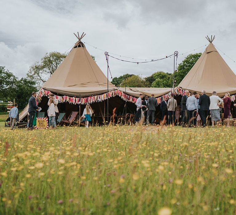 Tent complete with colourful bunting for outdoor wedding reception at Burrow Farm Gardens 