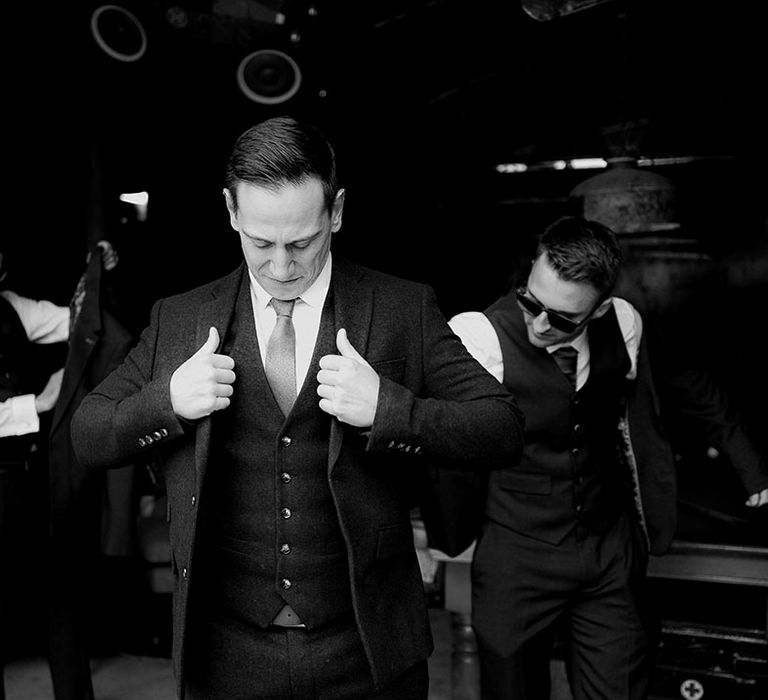 The groom and groomsmen all get ready and dressed for the wedding day wearing wedding outfits with burnt orange theme 