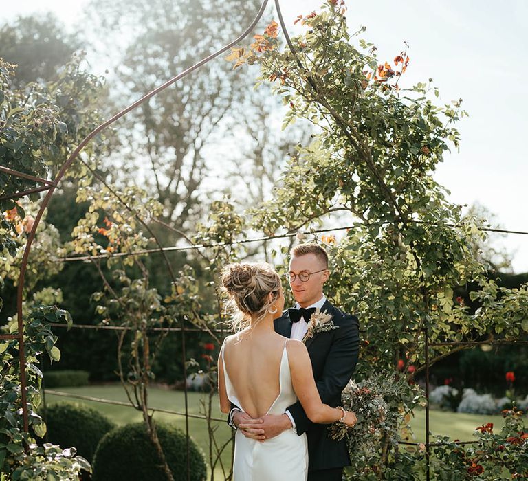 Elms Barn wedding with the bride in a low back wedding dress and groom in black tuxedo 