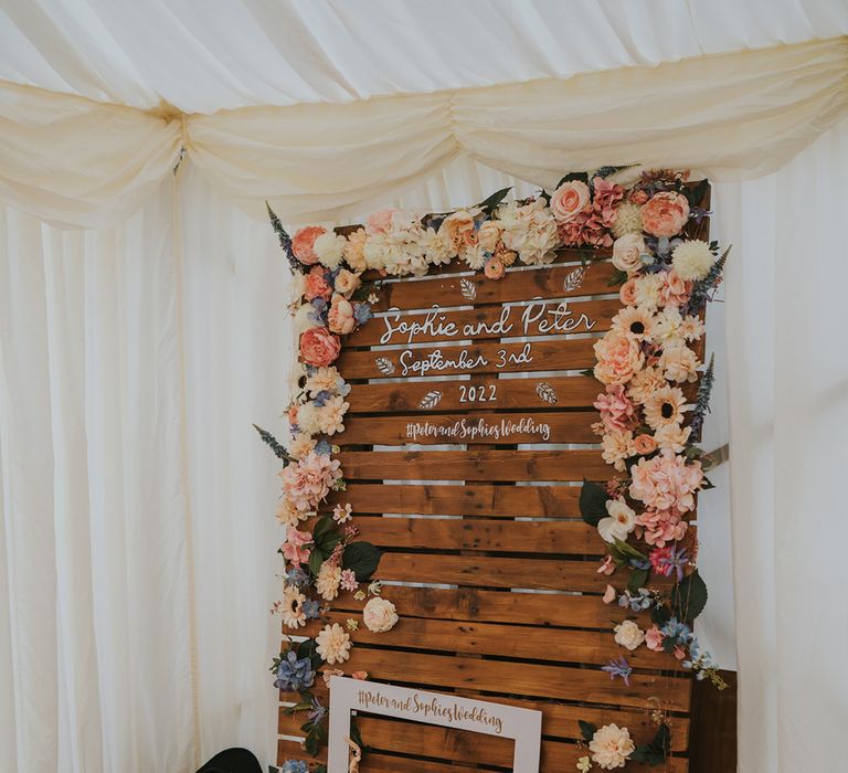 Rustic DIY wedding Photo Booth backdrop and flower decor with wider baskets full of props 