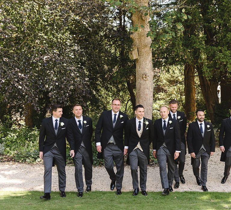 Groomsmen in matching black, grey, and navy morning suits with the groom for the luxury The Manor House wedding 