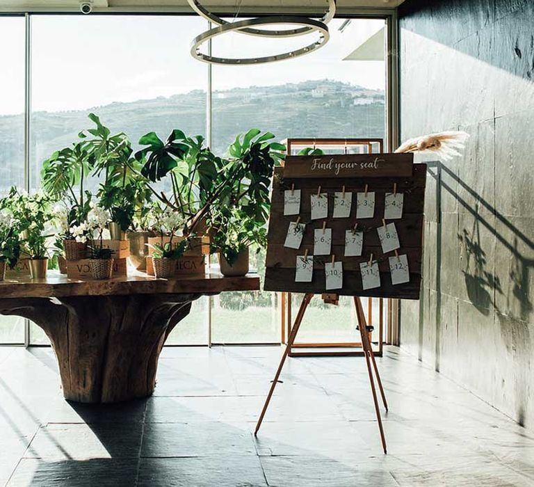 rustic table plan with wooden sign and plants 