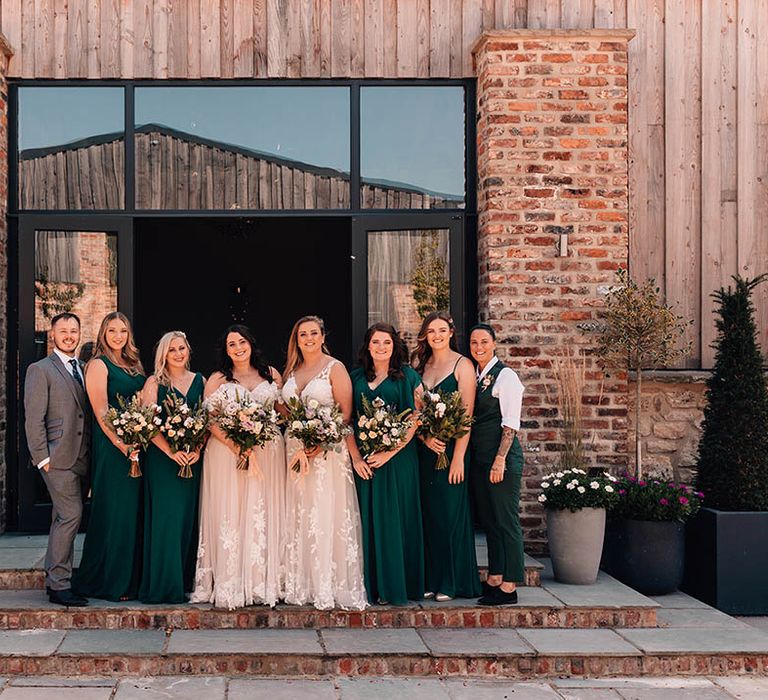 The wedding party with bridesmaids in green bridesmaid dresses, or green suits and bridesman in grey suit 