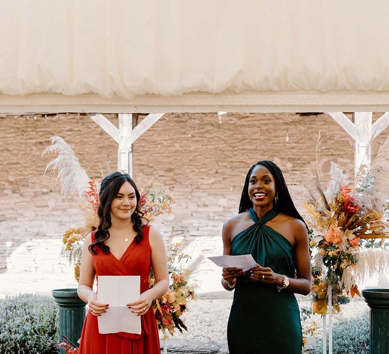 Bridesmaids in mismatched bridesmaid dresses at the alter of Broadfield Court doing bridesmaid speeches