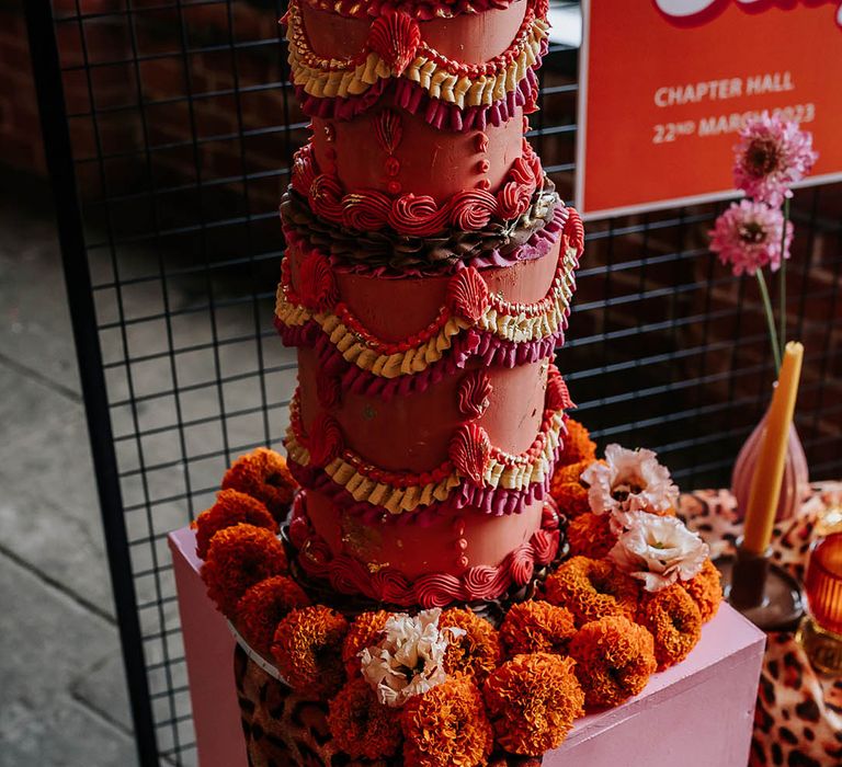 Epic and unique tall kitsch wedding cake with retro designs for 70s inspired wedding theme 