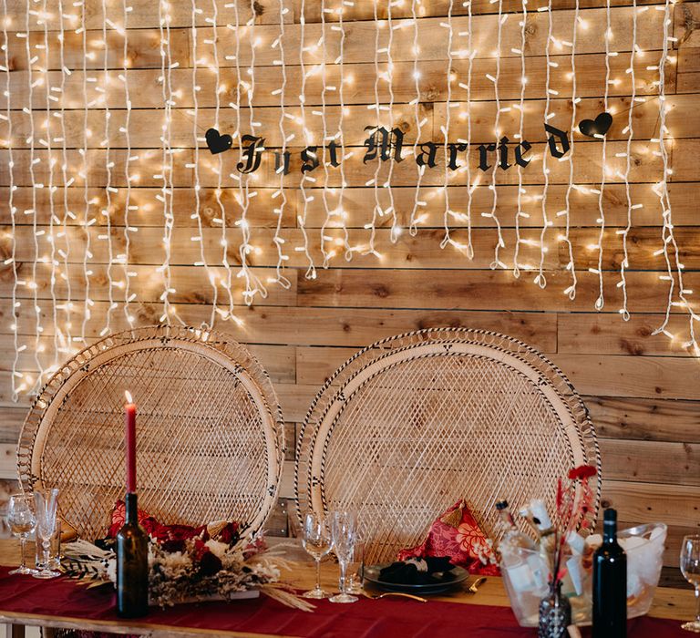 Southlands Barn wedding venue with fairy lights and two peacock chairs 