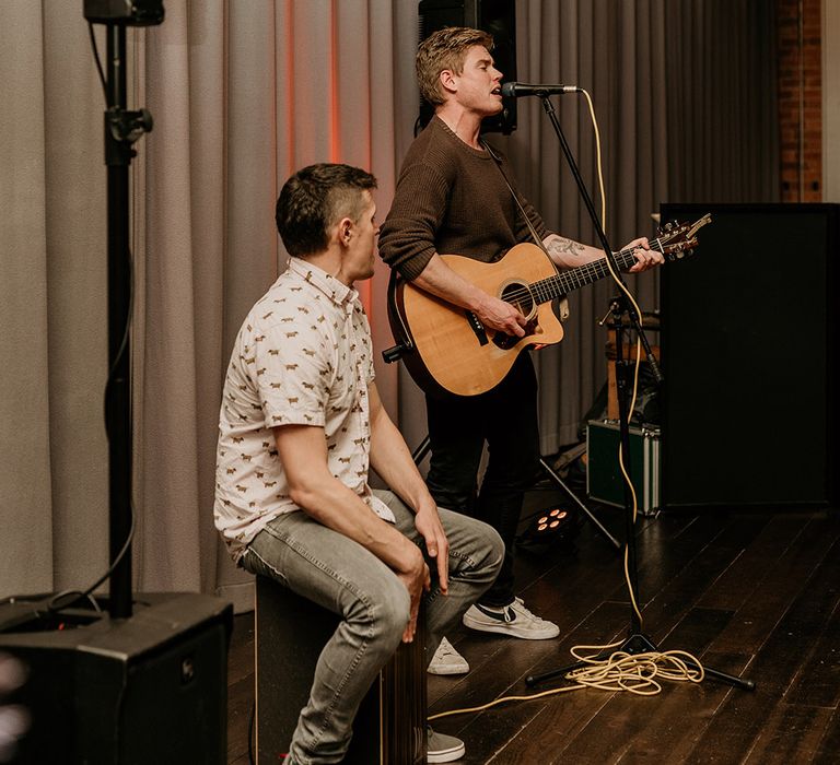 A wedding singer and guitarist perform at same sex wedding 