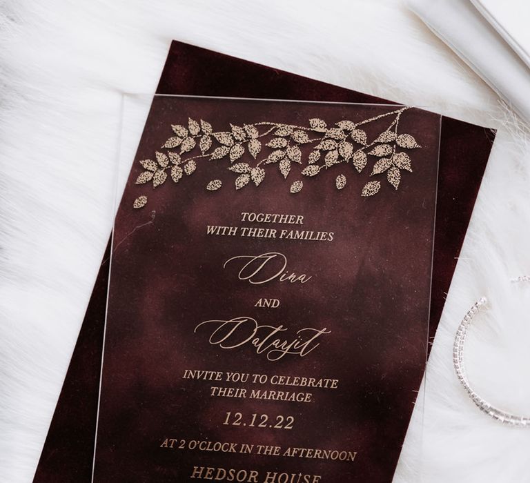 Clear acrylic wedding invitation with gold detailing 