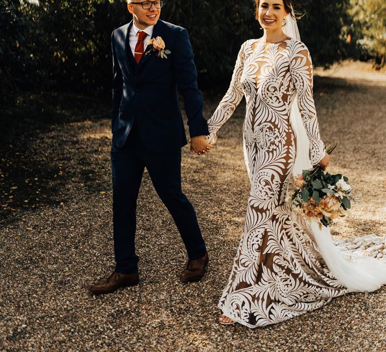 Bride in patterned lace wedding dress with sheer style 