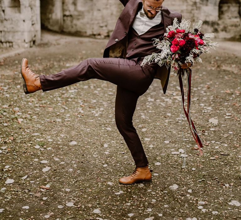 Groom in burgundy suit for gothic theme wedding 