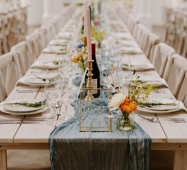 Dusty blue wedding theme table decor with pastel candles for coastal summer wedding 