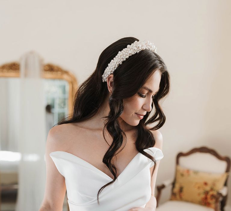 Bride in off the shoulder Pronovias wedding dress with pearl wedding headband 