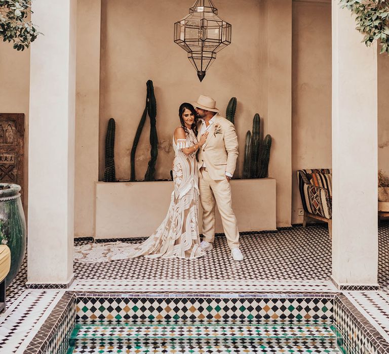 Groom reacts to seeing the bride in her dress for the first time and embraces her 