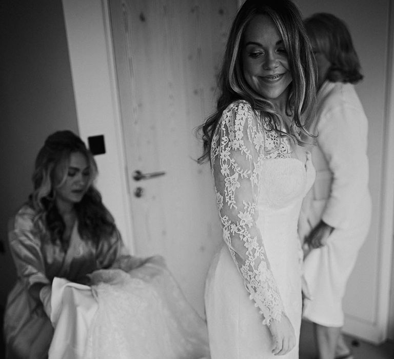 Bride in long sleeve traditional lace wedding dress by The Dress Teddington 