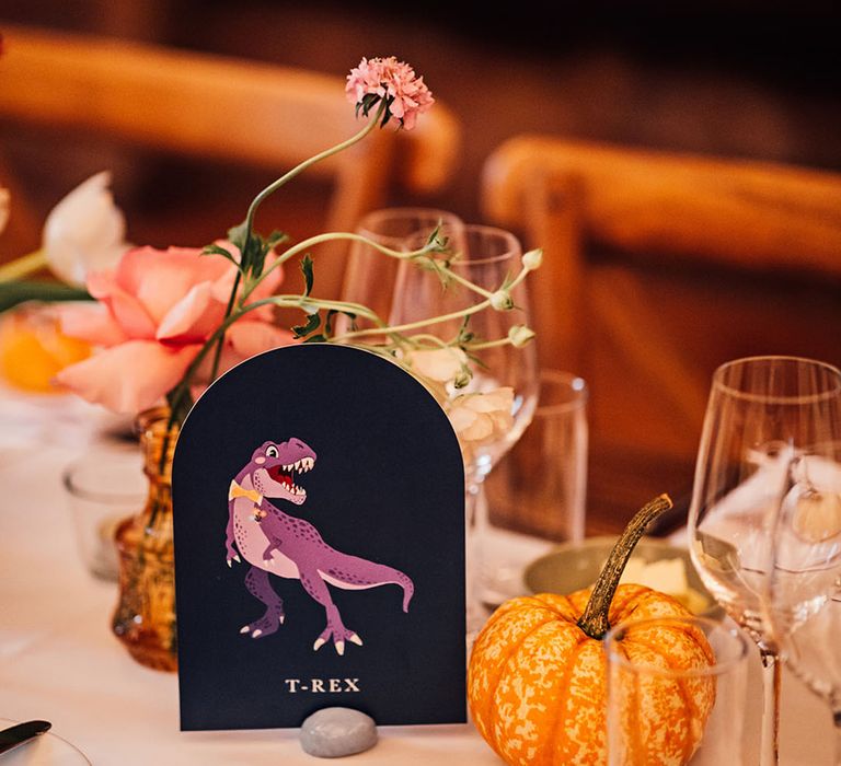 Dinosaur wedding table name signage with mini gourds