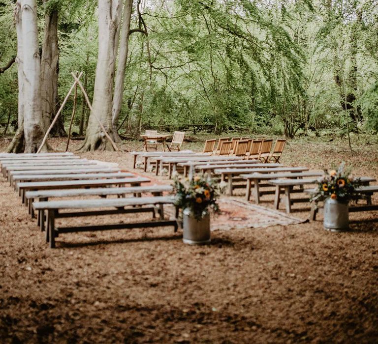 Wellington Wood in Norfolk wedding outdoor ceremony with wooden benches for guests 