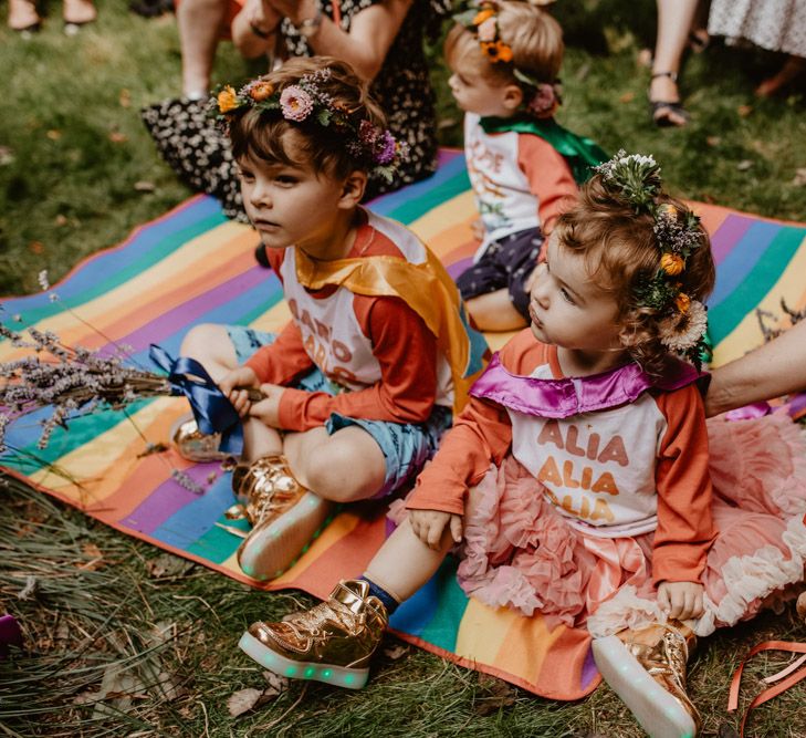 paige boys and flower girls sitting on rainbow blankets