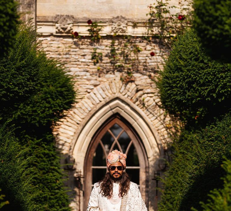 Groom in Ivory and gold traditional Indian outfit for the Hindu ceremony 