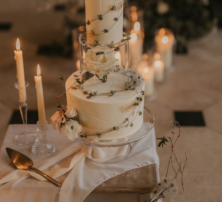 Buttercream wedding cake on glass cake stand 