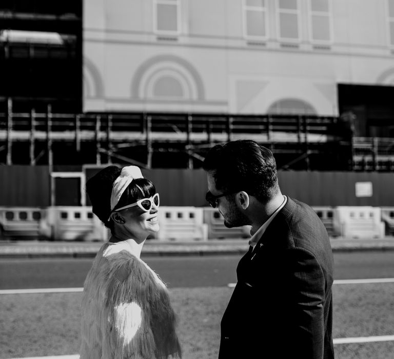 Stylish bride and groom in sunglasses