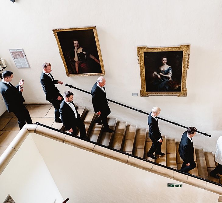 Groom and groomsmen walking down the steps to the wedding 