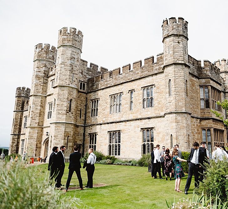 Wedding guests standing outside Leeds castle wedding venue