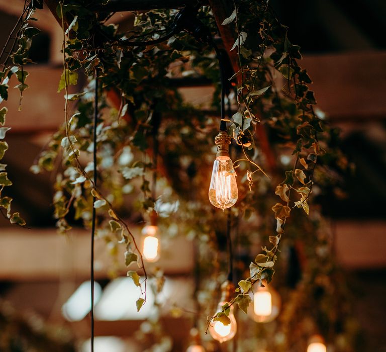 Hanging ivy and lighting above tables 