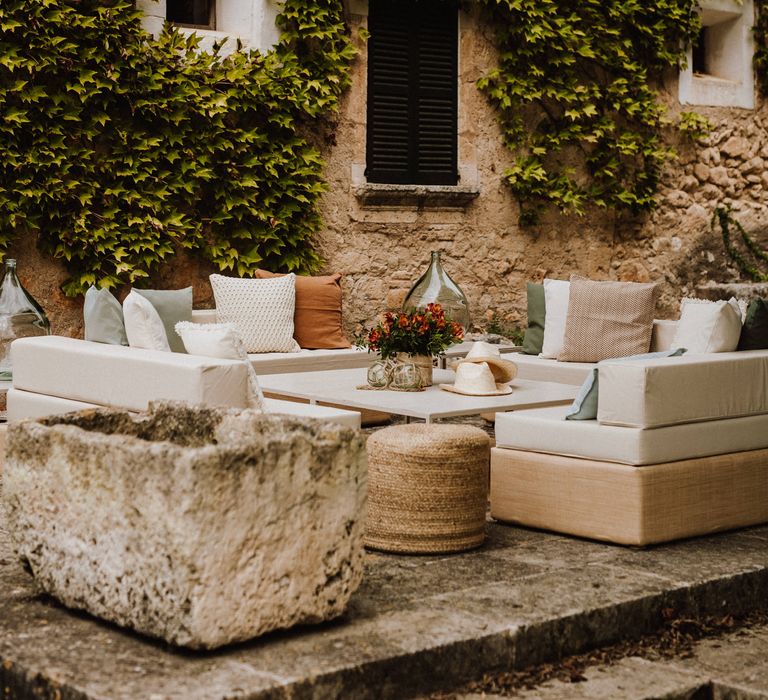 Outdoor setting in Mallorca with white corner sofa furniture and scatter cushions