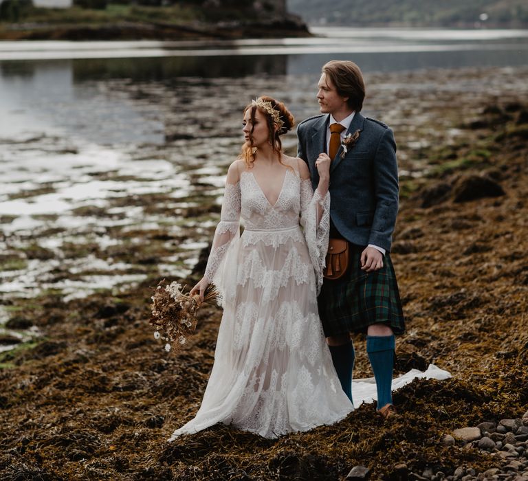 Bride & groom look out to sea during elopement