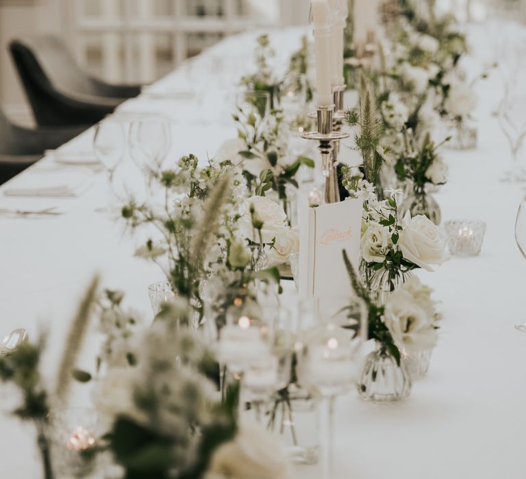 The Landmark London hotel wedding reception table with white tablecloth and small floral arrangements 