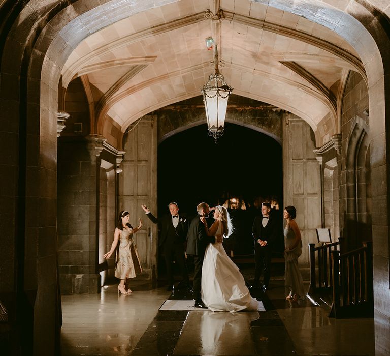 Bride & groom dance outdoors for first dance moment under arch at Markree Castle