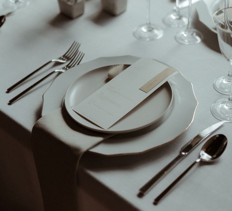 Minimalist decor for a simple elegant wedding table including dried grasses, bunny tails and white ceramics.