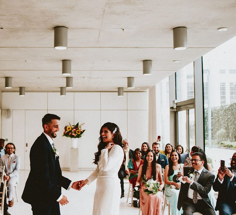 Bride and groom standing at the altar of their intimate Brent Civic Centre wedding ceremony 