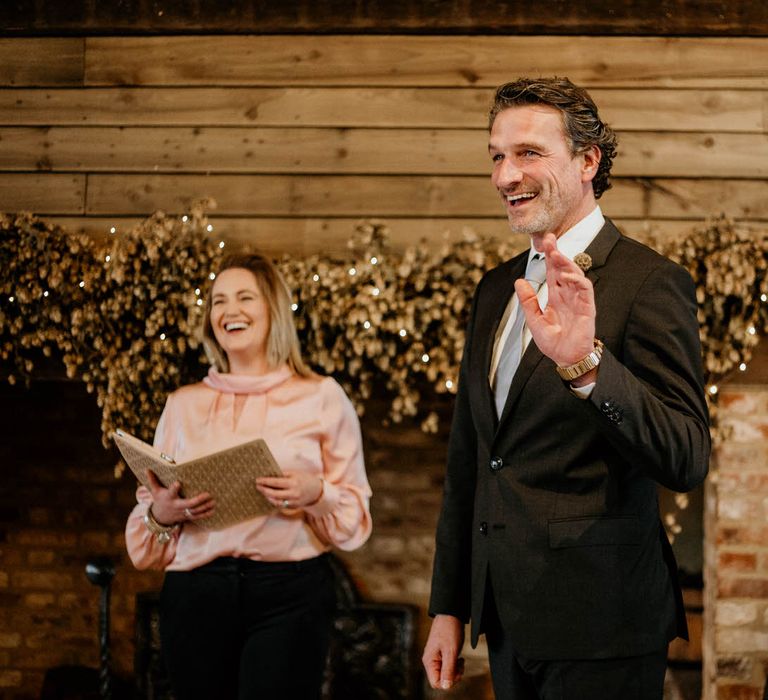 Groom and celebrant laughing at High Billinghurst Farm wedding ceremony