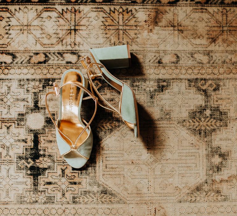 Worn patterned run with light blue block heels at garden wedding reception