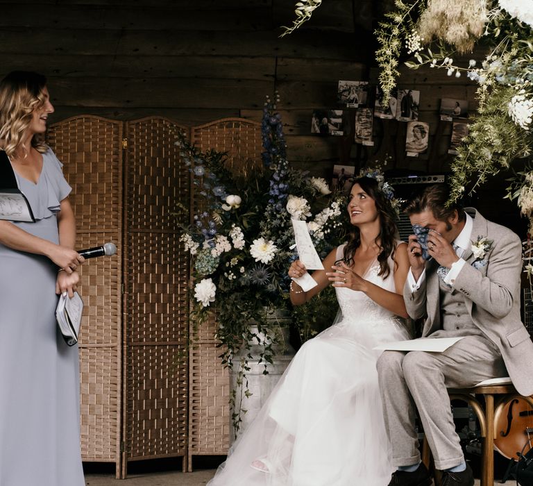 Groom becomes emotional during wedding reception as they both sit and listen