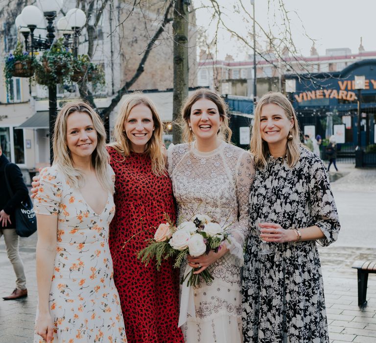 Bride stands with wedding guests for their reception after intimate wedding ceremony in Town Hall