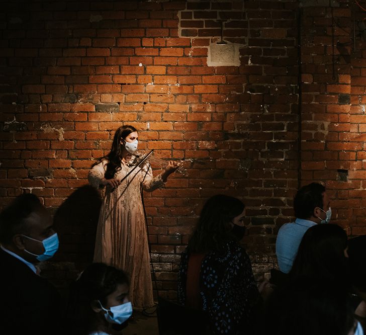 A violinist plays at a wedding ceremony. 