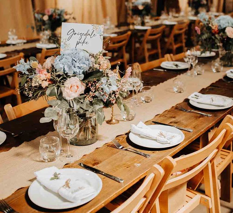 Pastel flower wedding table decor at rustic wedding