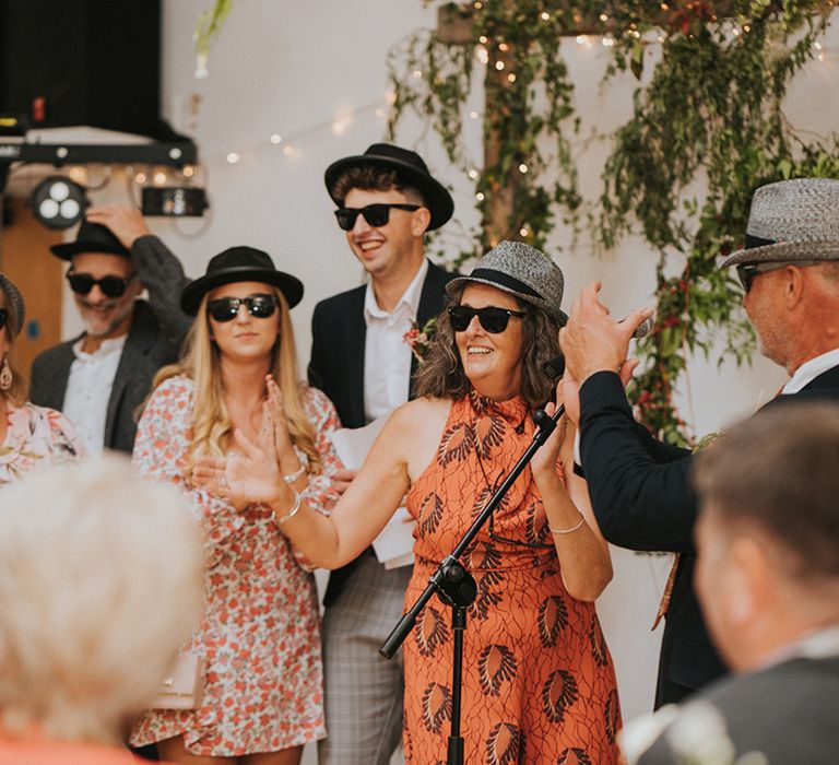 Wedding guests sing for couple on their wedding day