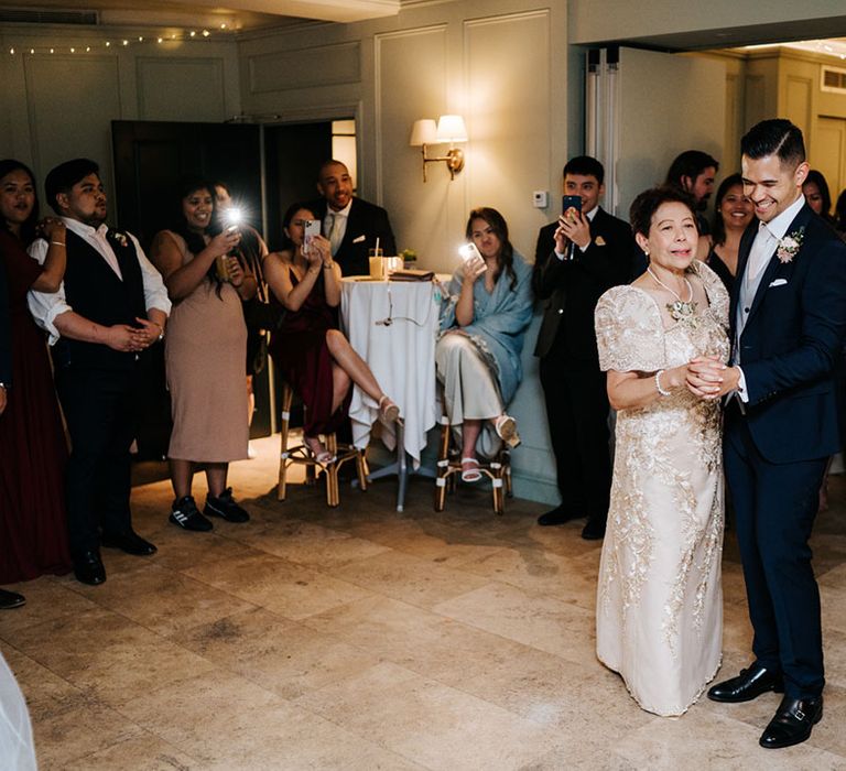 Groom and Mother of the Groom in a cream and gold lace dress first dance 