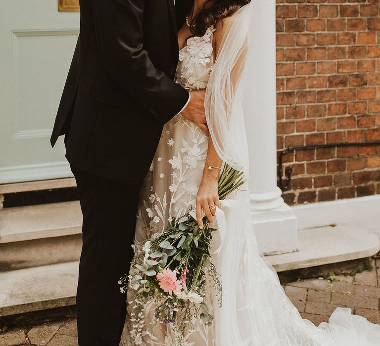 Groom kisses his brides forehead on their wedding day