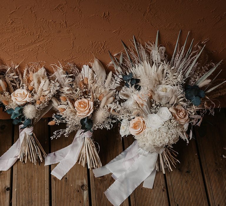 Dried florals complete with roses and pampas grass tied with white ribbon