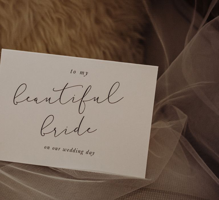 White wedding stationery with modern calligraphy reading 'to my beautiful bride on our wedding day'