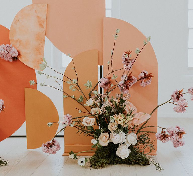 colour board backdrop with delicate flower arrangement at asian wedding