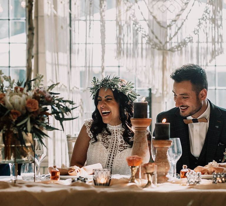 Bride & groom sit at head table on their wedding day