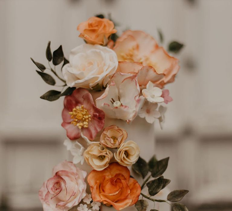 Iced wedding cake with intricate sugar flower decoration by Bluebell Kitchen 