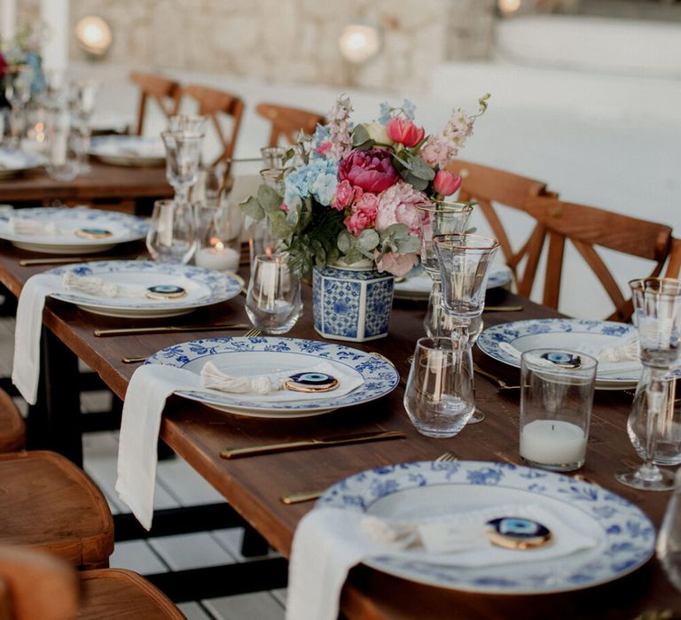 White and blue china plates complete with Evil Eye decorative piece 