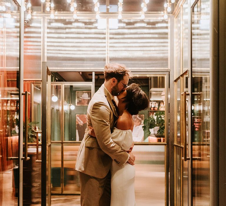 Bride and groom kiss at their industrial wedding venue, Holmes Mill