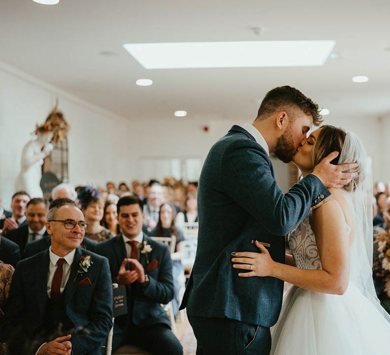 Bride and groom share their first kiss as a married couple 